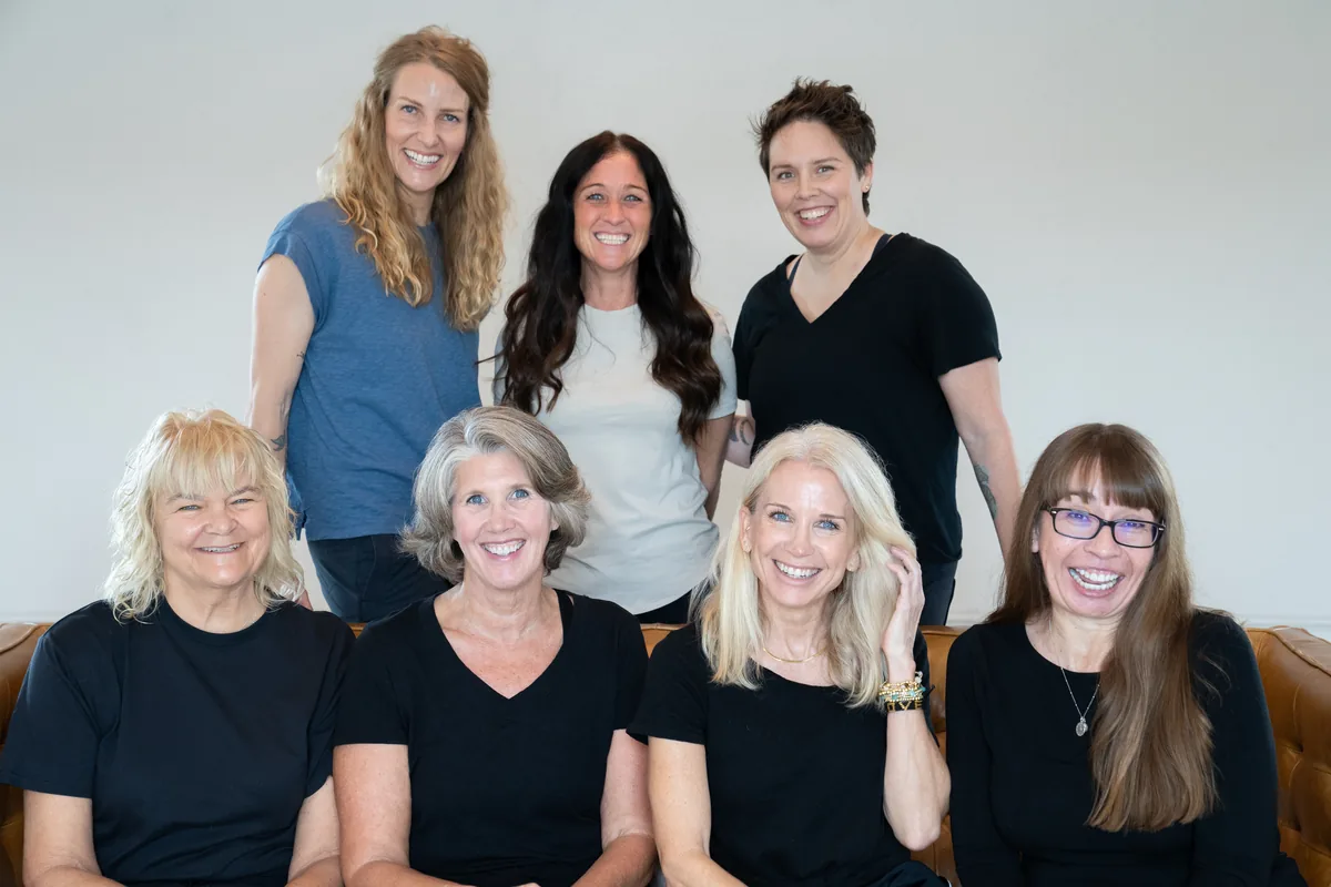 Indigo Yoga team portrait — seven members of the Indigo community together.
